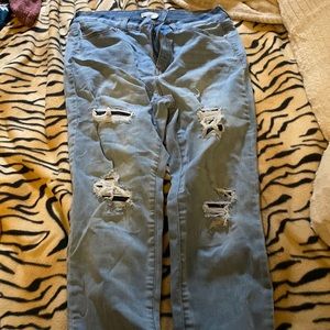 Light blue jeans with holes covered